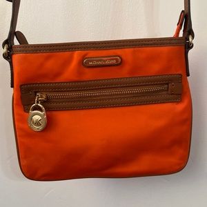 Authentic Michael Kors orange nylon crossbody bag with brown leather trim